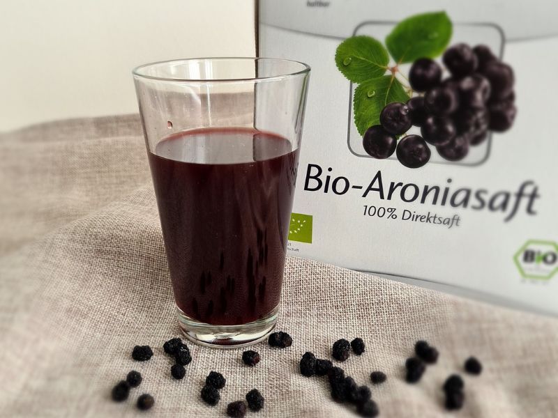 Aroniasaft im Glas mit Saftbox